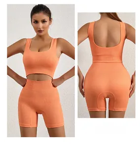 Detail of orange ribbed sports set featuring a U-neck crop top and high-waisted shorts