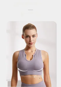 Detail view of purple ribbed sports bra with U-neck design and elastic textured fabric