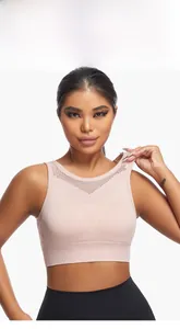 Detail of pink sports bra featuring breathable hollow mesh knit and seamless wide underband