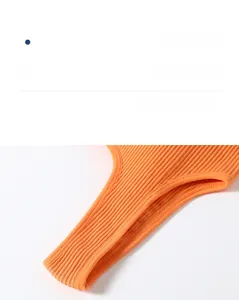 Detail of vibrant orange sports bra featuring premium ribbed knit fabric and neat stitching