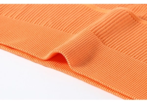 Detailed close-up of the orange ribbed knit hem on a high-elastic sports bra