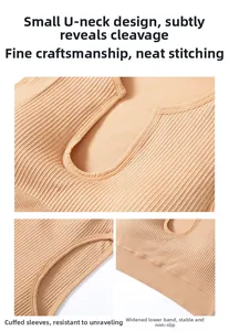 Detail view of U-neckline, seamless edging, and ribbed elastic hem on pink sports bra