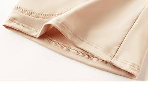 Detail of high-elasticity fabric with fine double-needle stitching on beige shapewear