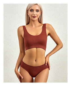 Detail of ribbed knit fabric texture on rust red seamless wireless bralette set