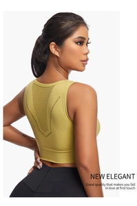 Close-up of mustard green sports bra featuring V-shaped mesh knit and cutout back detail