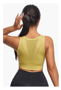 Detail of green sports bra featuring breathable mesh cutout and wide ribbed band
