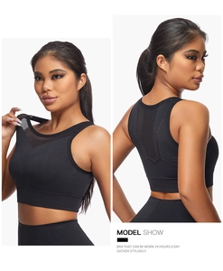 Detail view of black sports bra featuring mesh hollow-out back and wide elastic support band