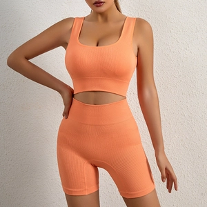 Vibrant orange ribbed two-piece yoga set with U-neck sports bra and high-waist shorts
