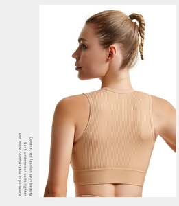 Close-up of beige ribbed knit sports bra with seamless back and elastic texture