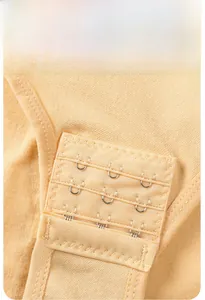 Detail of adjustable triple-row hook-and-eye crotch closure on beige bodysuit