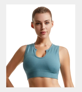 Detail of ribbed teal sports bra with a small U-neck cutout and wide elastic waistband