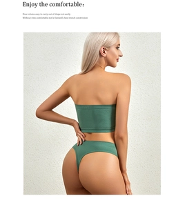 Detail of dark green ribbed backless bralette set showing seamless fabric texture