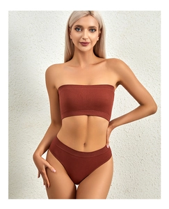 Close-up of seamless ribbed knit lingerie set in rust red featuring a thin padded bralette