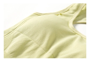 Detail of light green ribbed yoga bodysuit featuring integrated padded sports bra cups