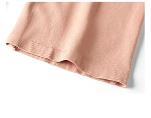 Detail of pink ribbed fabric hem showing high-quality double-stitch sewing craftsmanship