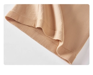 Close-up of beige ribbed knit fabric showing soft texture and wide rolled edge detail