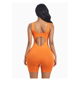 Close-up of orange yoga bodysuit featuring a unique heart-shaped cutout detail on back