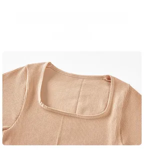 Close-up of the square neckline and ribbed knit texture on the beige mini dress