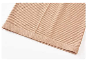 Close-up of beige ribbed knit fabric showing high-elasticity texture and fine craftsmanship