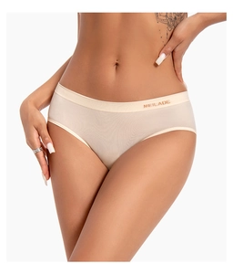 Detailed close-up of seamless beige panties with lettered elastic waistband and soft fabric