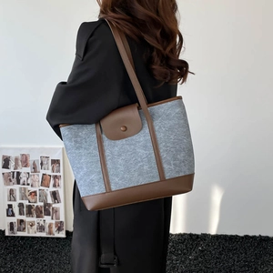 Chic grey felt and brown leather tote bag for women shown as a stylish shoulder bag