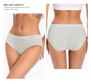 Detail view of mint green seamless mid-rise panties showing the logo waistband and fit