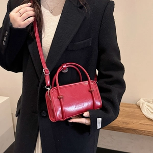 Minimalist red faux leather handbag with embossed FASHION lettering and twin top handles