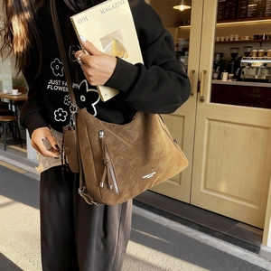Brown large capacity suede tote bag with fringe charm and small pouch on shoulder