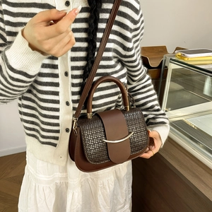 Brown crocodile texture saddle bag with gold metal trim and adjustable strap