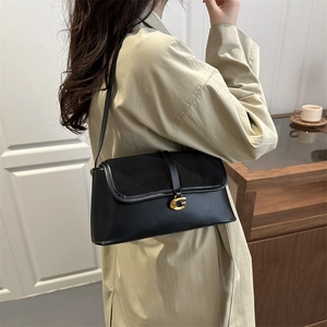 Vintage black leather shoulder bag featuring a gold G buckle and elegant suede flap