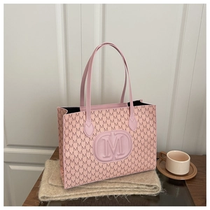 Detailed close-up of pink tote bag featuring M pattern prints and sleek leather texture