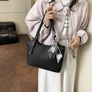 Black pebble leather tote bag with geometric silk scarf handle for commute