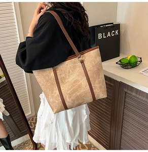 Detail of premium brown tote bag with vintage marble texture and leather handles