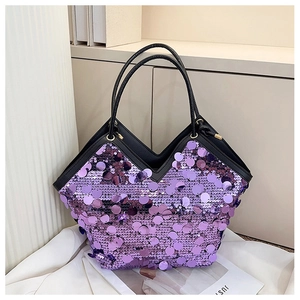 Detail of purple sequin tote bag with black leather trim and golden metal buckles