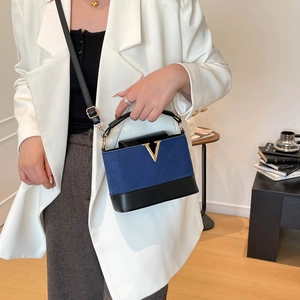 Navy blue matte contrast crossbody bag with gold V accent and black top handle