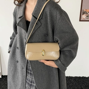 French style beige rectangular shoulder bag with gold U-shaped lock on a model