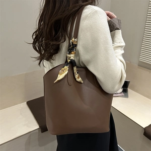 Large dark brown leather tote bag with printed silk scarf detail on handle for women
