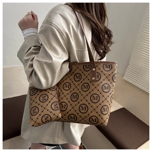 Detail of the vintage monogram tote set featuring a matching clutch and brown M-print