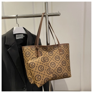 Close-up of brown monogram tote bag set with golden hardware and matching pouch