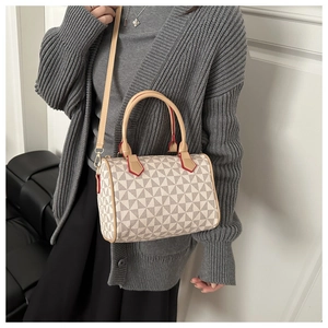 Detail view of printed Boston bag featuring geometric patterns and red contrast edges