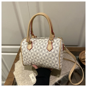 Detail of Boston bag showing geometric pattern, red edge finish, and detachable strap