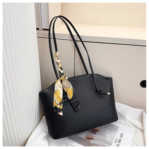 Detail of black PU leather tote bag with white contrast stitching and silk scarf accessory
