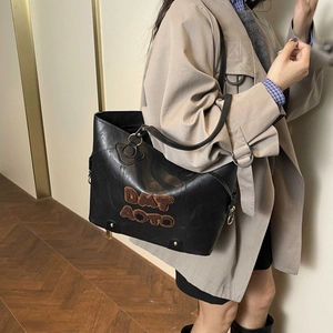 Retro black leather tote bag with plush letter detail and long shoulder straps