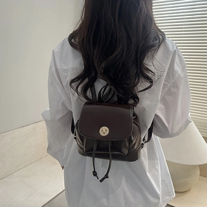 Minimalist dark brown backpack for women featuring drawstring closure and flap design