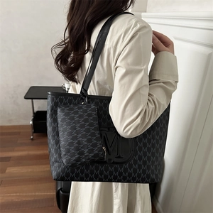 Classic black monogram tote bag with small pouch and embossed M logo on shoulder