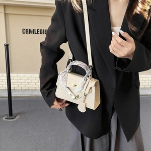 Chic beige crocodile texture trapezoid handbag with scarf-wrapped handle and metal lock
