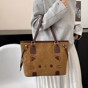 Brown cat themed tote bag with leopard texture and metal rings shown on shoulder