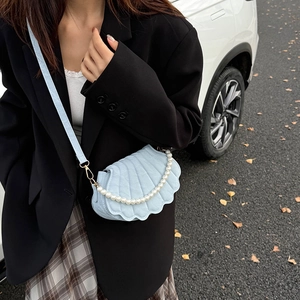 Light blue shell shaped crossbody bag with pearl strap and scalloped flap edge