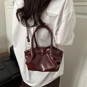 Fashionable dark red bucket bag with pleated design and golden ring handles