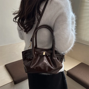 Chic dark coffee pleated bucket bag with metallic detail and shiny finish for daily commute